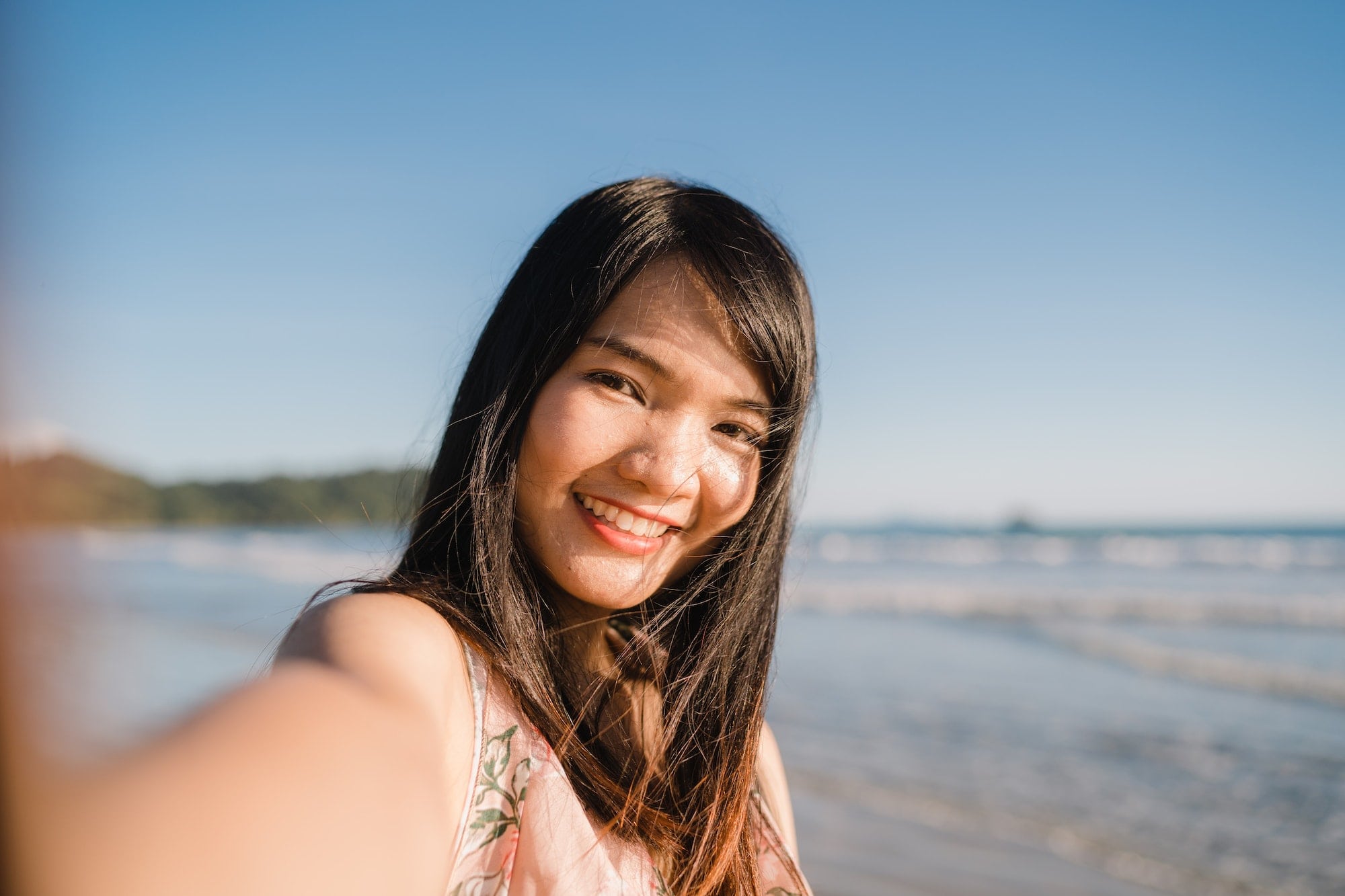 Tourist Asian woman selfie on beach.